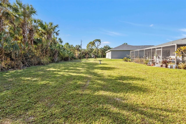 view of yard featuring a sunroom