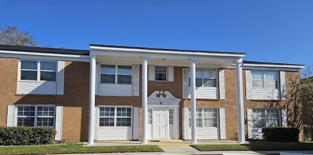 townhome / multi-family property featuring brick siding