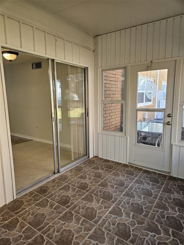 unfurnished sunroom with visible vents