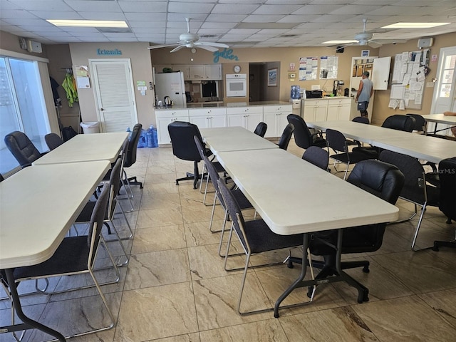 office with a paneled ceiling and ceiling fan