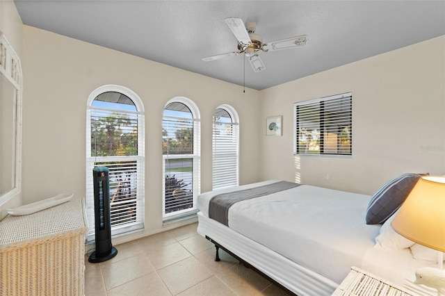 bedroom with light tile patterned floors and ceiling fan