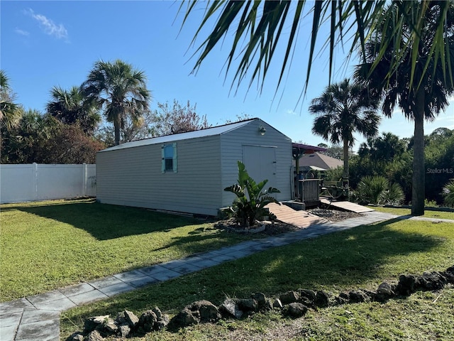 view of property exterior with a storage shed and a yard