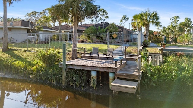 dock area featuring a lawn and a water view