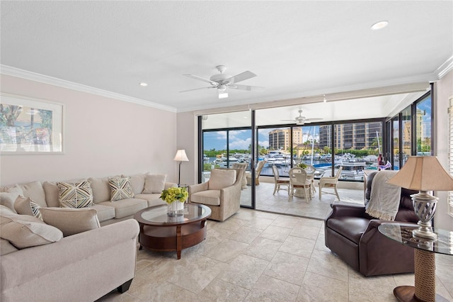 living room featuring ceiling fan, ornamental molding, and floor to ceiling windows