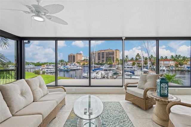 sunroom with a water view and ceiling fan