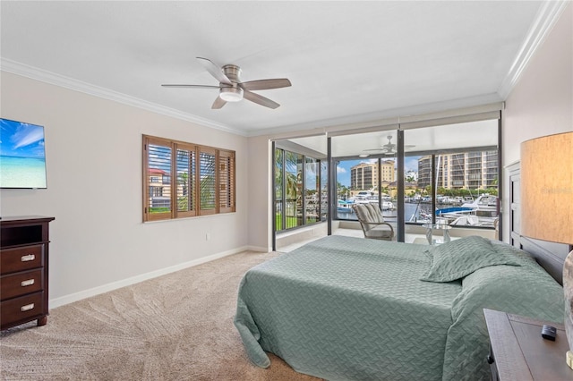 carpeted bedroom featuring crown molding and ceiling fan