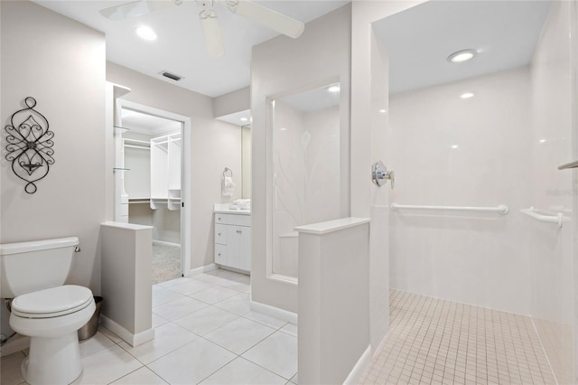 bathroom with vanity, toilet, walk in shower, and tile patterned flooring