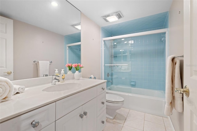 full bathroom featuring vanity, shower / bath combination with glass door, toilet, and tile patterned flooring