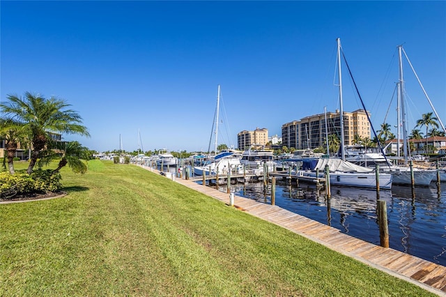 view of dock featuring a yard and a water view