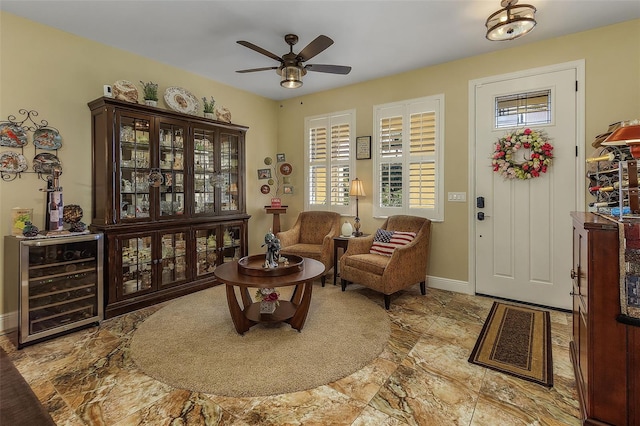 sitting room with wine cooler and ceiling fan