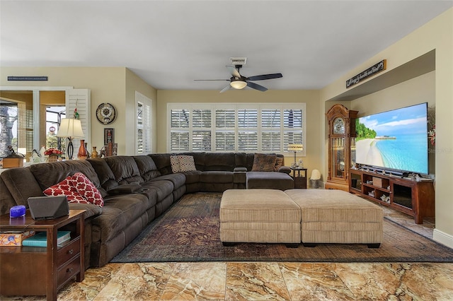 living room with a healthy amount of sunlight and ceiling fan