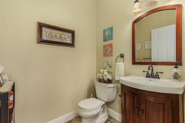 bathroom featuring vanity, toilet, and tile patterned floors