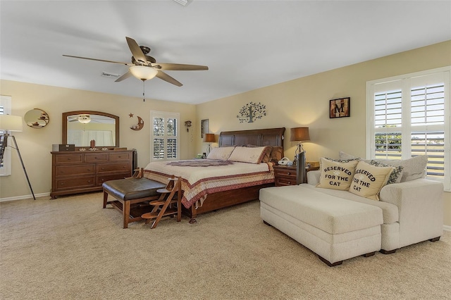 bedroom with ceiling fan and light colored carpet