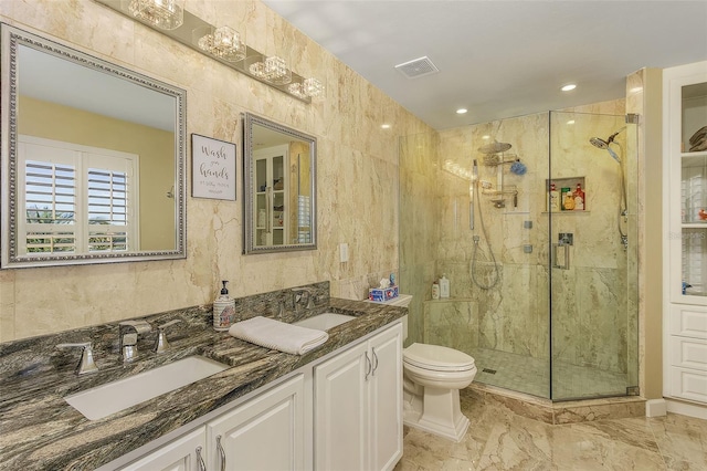 bathroom with vanity, toilet, walk in shower, and tile walls