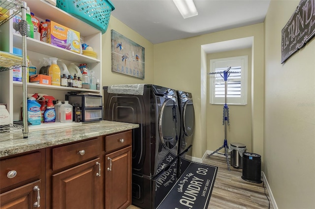 laundry room featuring light hardwood / wood-style floors and washer and clothes dryer