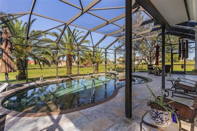 view of swimming pool featuring a yard, a patio area, and glass enclosure