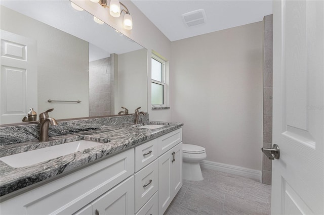 bathroom with vanity, toilet, and tile patterned flooring