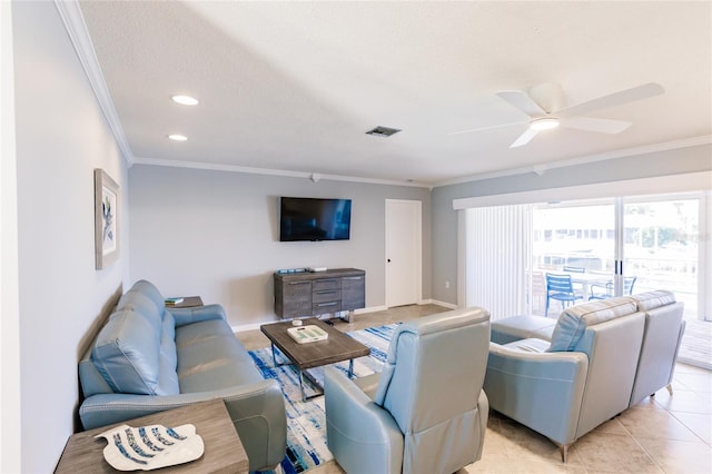 tiled living room featuring ornamental molding, a textured ceiling, and ceiling fan