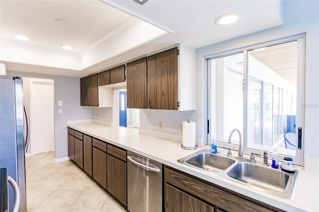 kitchen with appliances with stainless steel finishes, sink, dark brown cabinetry, ornamental molding, and light tile patterned floors