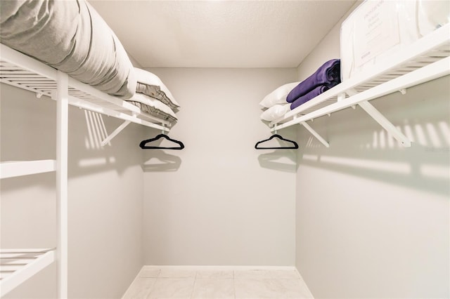 spacious closet with tile patterned flooring