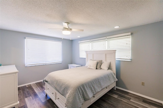 bedroom with a textured ceiling, ceiling fan, and dark hardwood / wood-style flooring