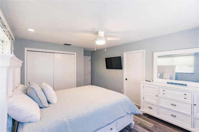 bedroom featuring a closet, ceiling fan, and dark hardwood / wood-style flooring