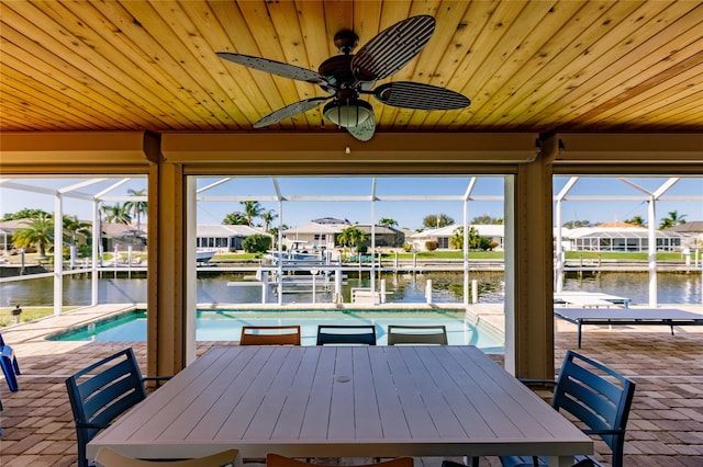 dock area with a water view, a patio area, and a lanai