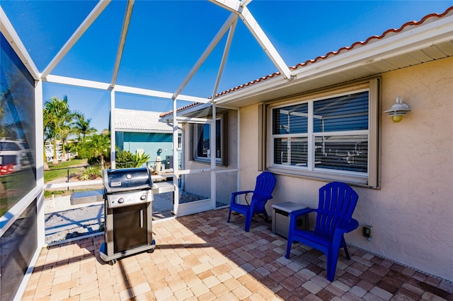 view of patio / terrace featuring a lanai and grilling area