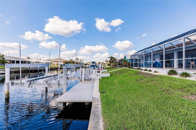 dock area with a water view, a lanai, and a yard