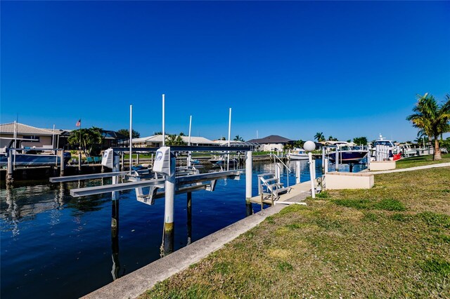 dock area featuring a yard and a water view