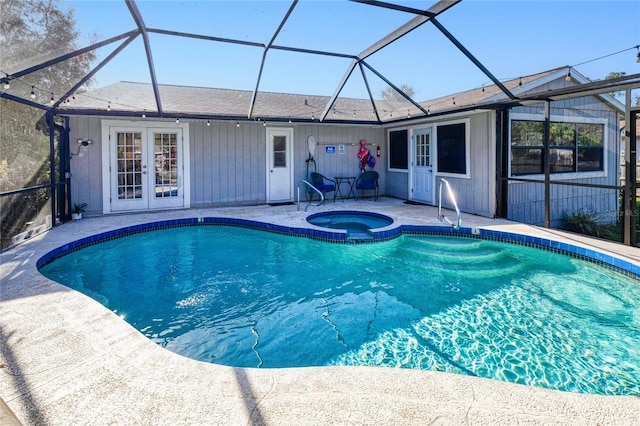 view of pool with a patio, a lanai, and an in ground hot tub