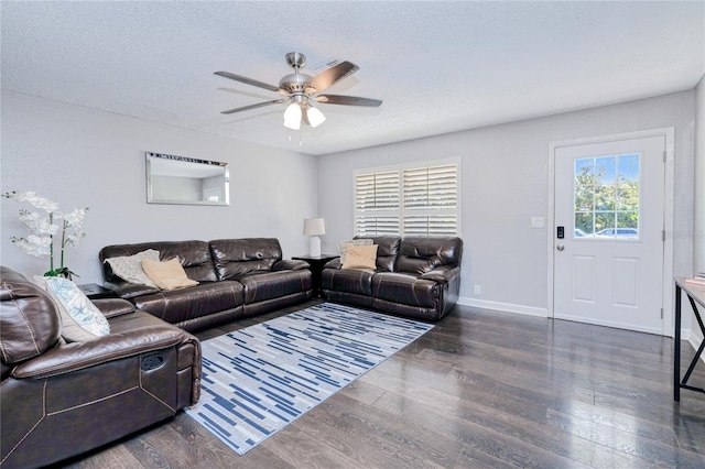 living room featuring ceiling fan, plenty of natural light, and dark hardwood / wood-style floors