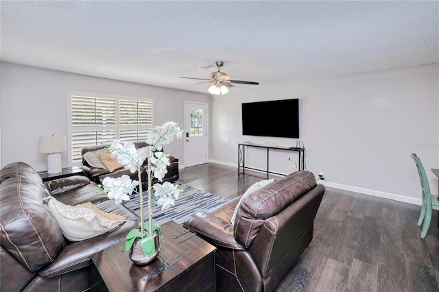 living room with a textured ceiling, dark hardwood / wood-style floors, and ceiling fan