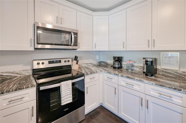 kitchen featuring stainless steel appliances, a textured ceiling, dark hardwood / wood-style floors, and white cabinets