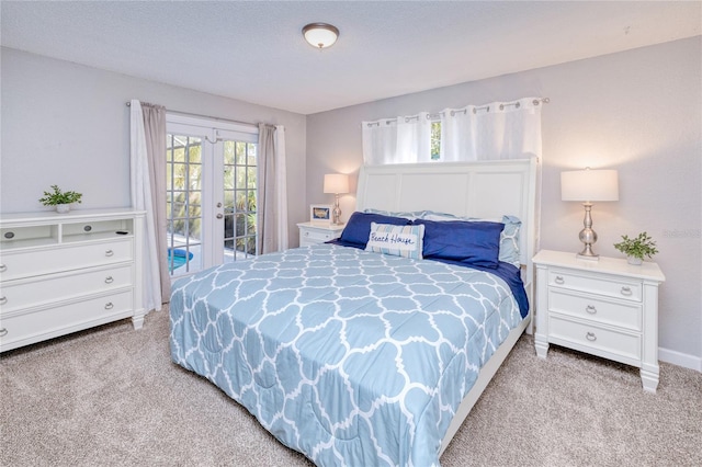 carpeted bedroom with french doors and access to outside