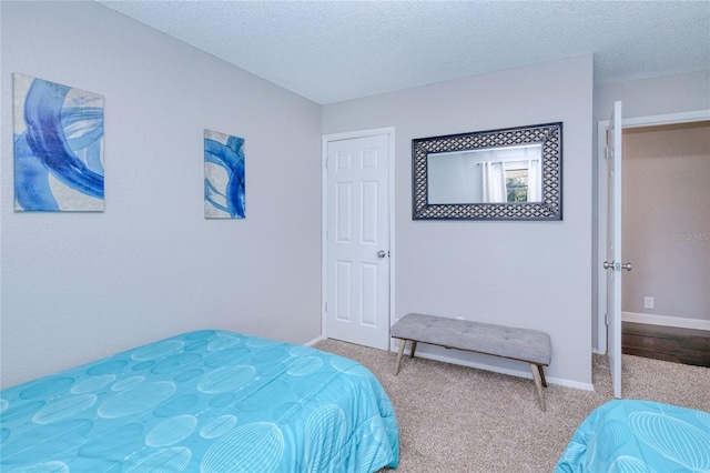 carpeted bedroom featuring a textured ceiling