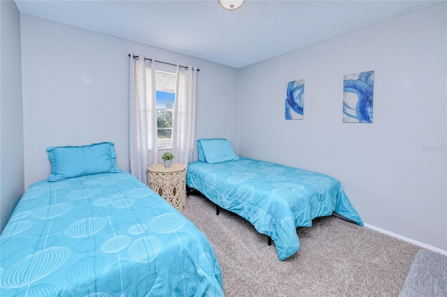 bedroom featuring a textured ceiling and carpet