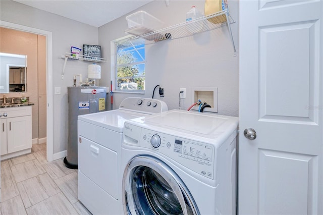 washroom featuring water heater and independent washer and dryer