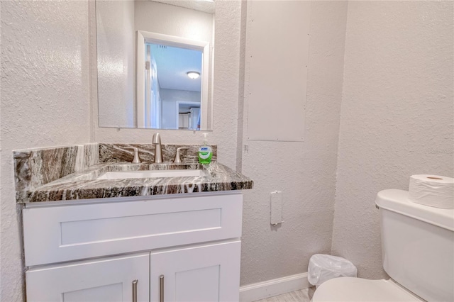 bathroom featuring toilet and vanity