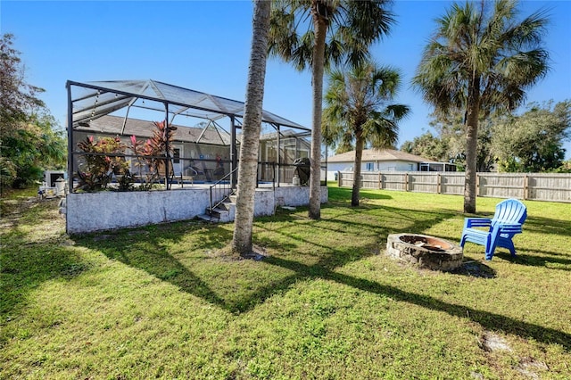 view of yard with an outdoor fire pit and glass enclosure