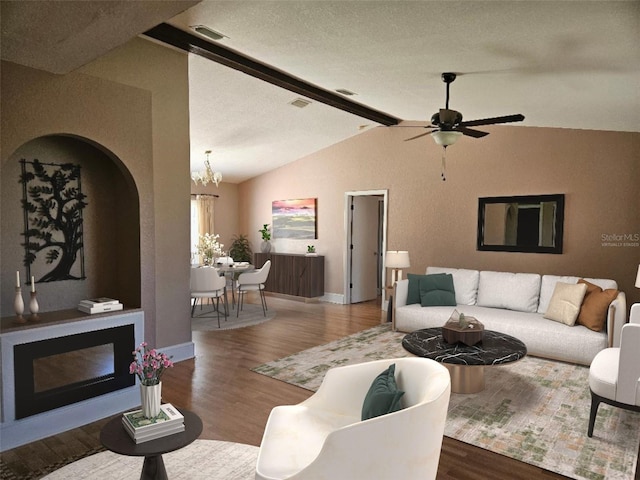 living room with a textured ceiling, hardwood / wood-style flooring, vaulted ceiling with beams, and ceiling fan with notable chandelier