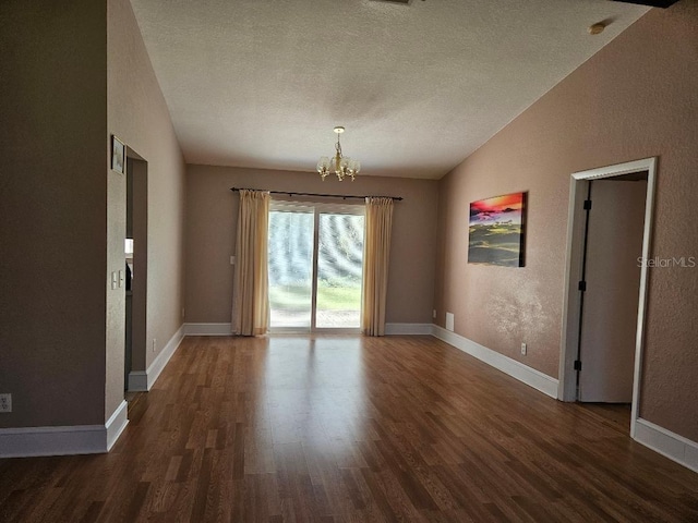 unfurnished room featuring a chandelier, a textured ceiling, lofted ceiling, and dark hardwood / wood-style floors