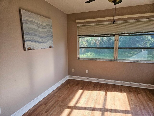 spare room with wood-type flooring and ceiling fan