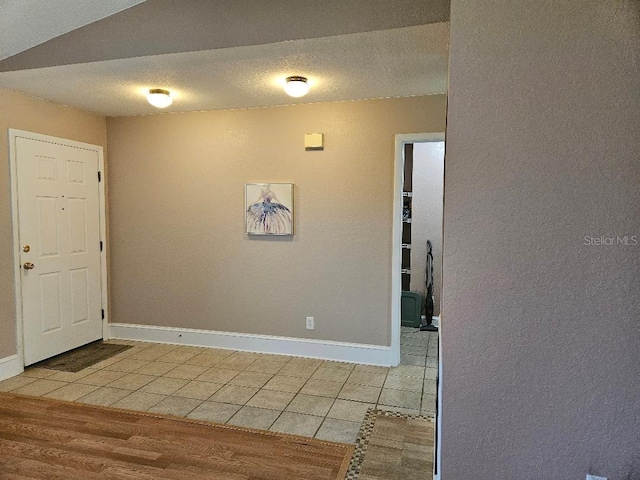 foyer with light hardwood / wood-style floors and a textured ceiling