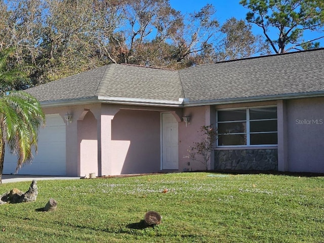 single story home featuring a garage and a front yard