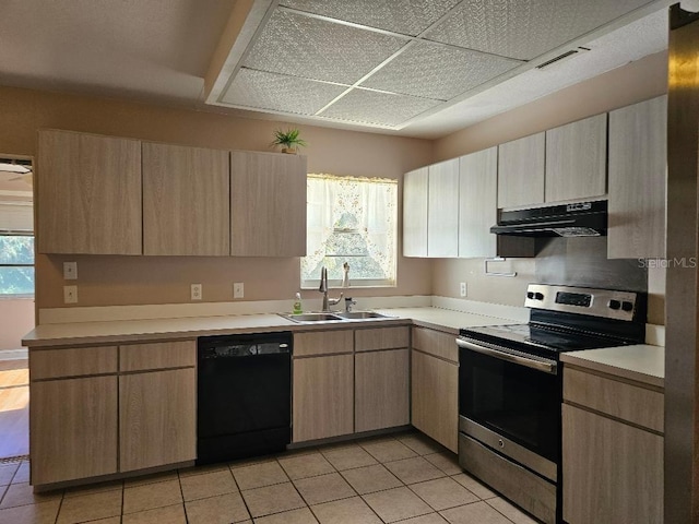 kitchen with dishwasher, stainless steel electric range, sink, and light tile patterned flooring