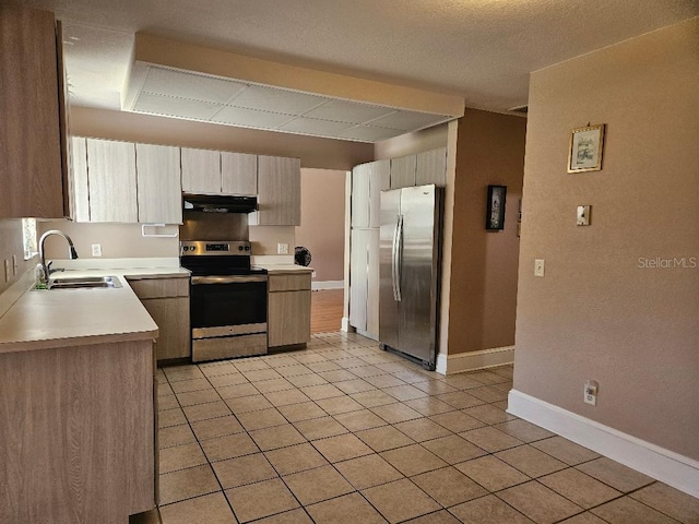 kitchen with light tile patterned floors, sink, and appliances with stainless steel finishes