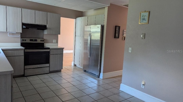 kitchen featuring ventilation hood, appliances with stainless steel finishes, and light tile patterned floors