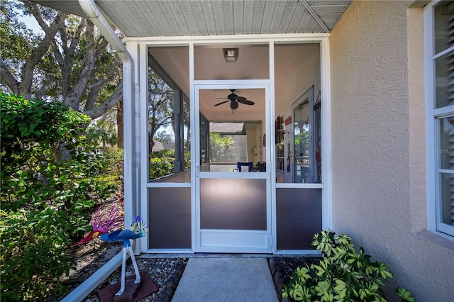 view of exterior entry featuring ceiling fan