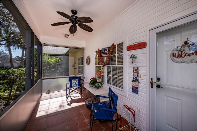 sunroom featuring ceiling fan